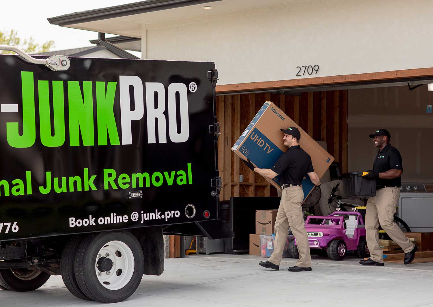 1-800-JunkPro Junk Removal Workers loading a truck
