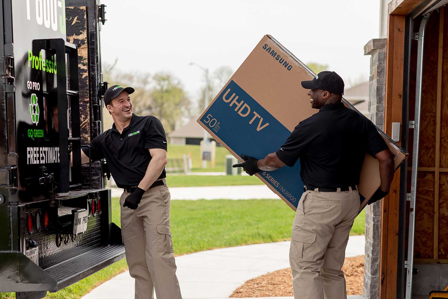 1-800-JunkPro Junk Removal team removing junk from a garage
