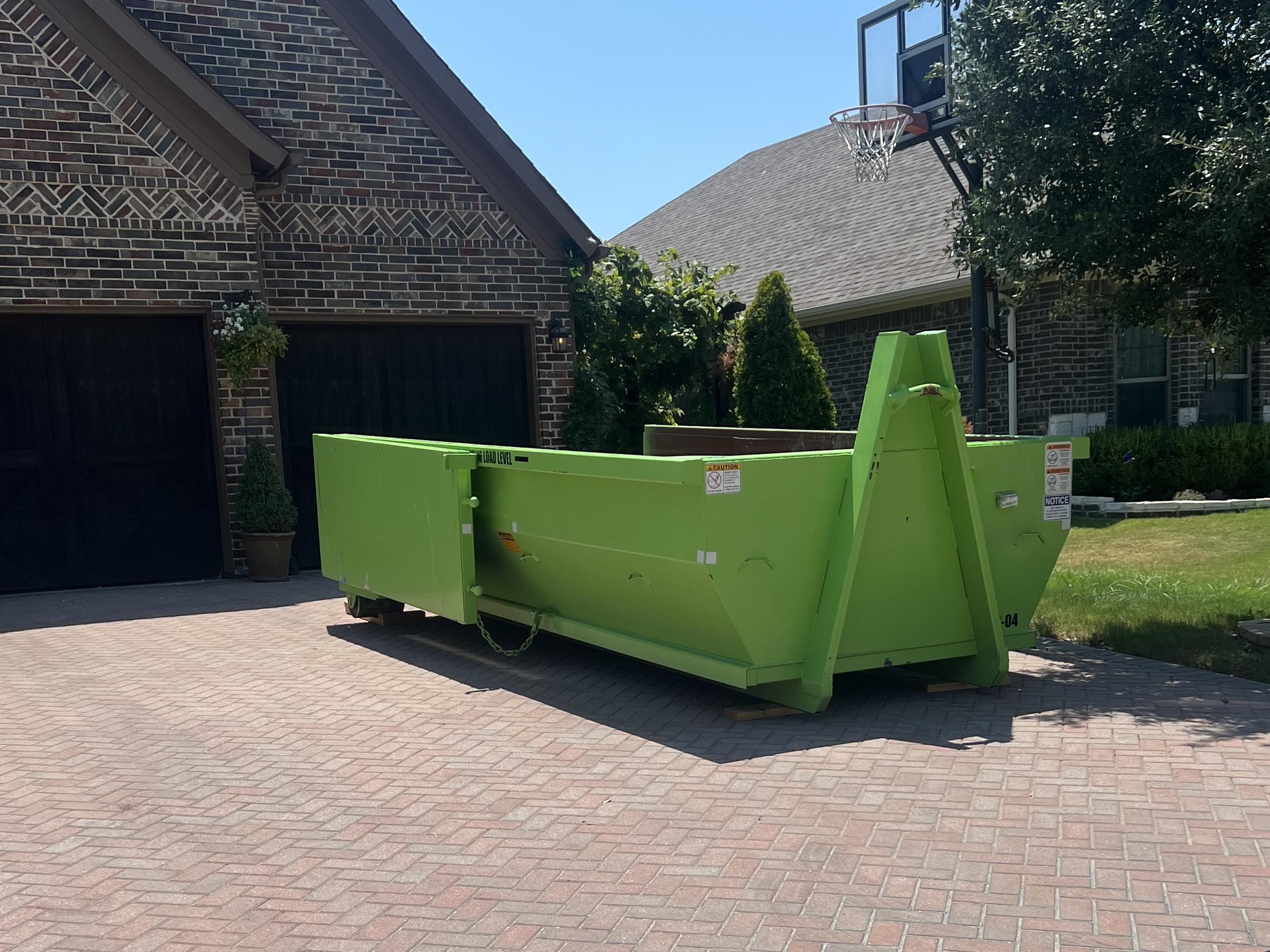 A 1-800-JunkPro Rental Dumpster in a Residential Driveway