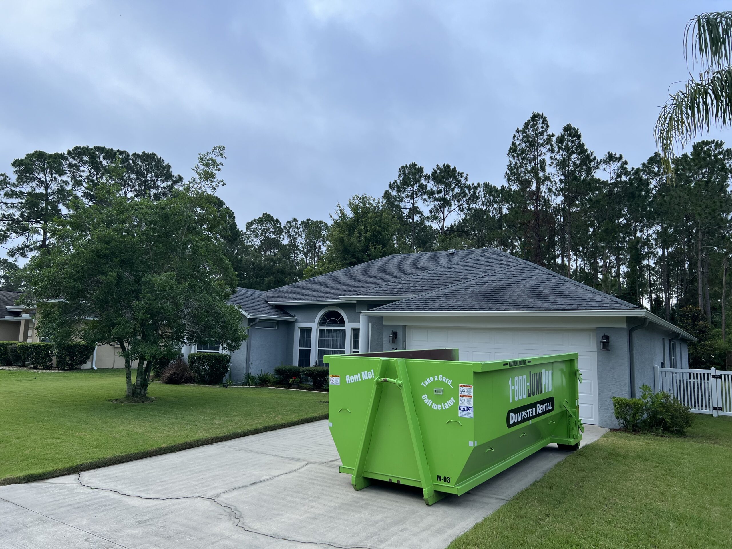 A Large Rented Dumpster in a Residential Driveway